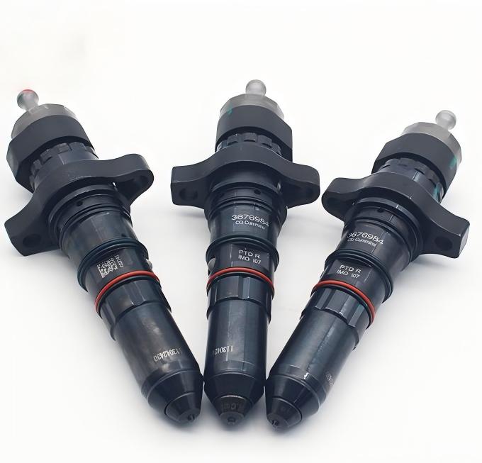 Three Cummins diesel injectors – black units with red seals and engraved part numbers, core components for diesel engine fuel injection.