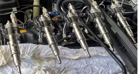 Clean diesel injectors laid out, proper care of these parts is a critical fuel-saving tip for efficient generator operation